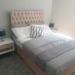 Modern bedroom with double bed and two nightstands.